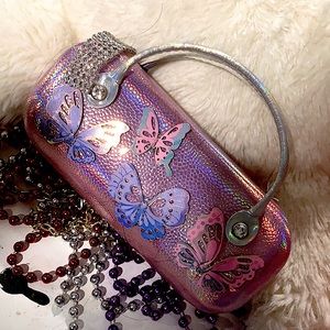 The color is pink and has butterflies 🦋 on the front also has handles to carry.